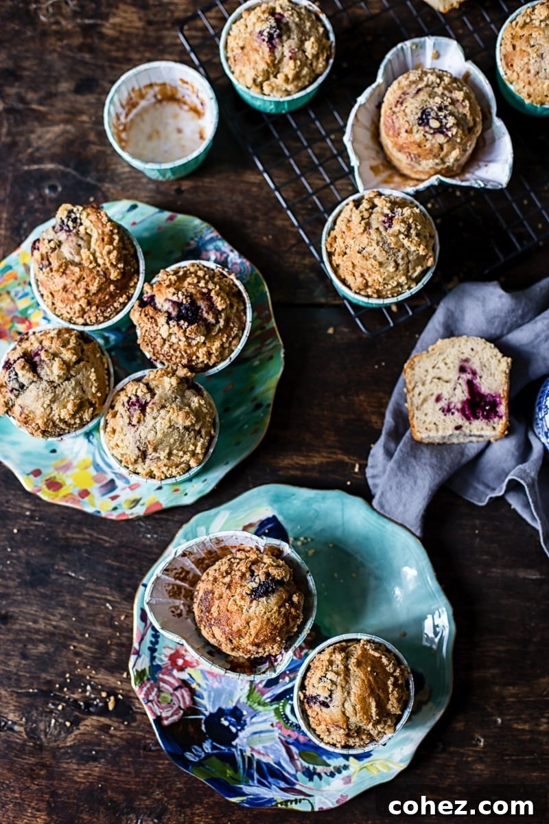 Signature Blackberry Muffins 5 A spread of freshly baked Bakery Style Blackberry Muffins, showcasing their perfect golden tops and inviting appearance.
