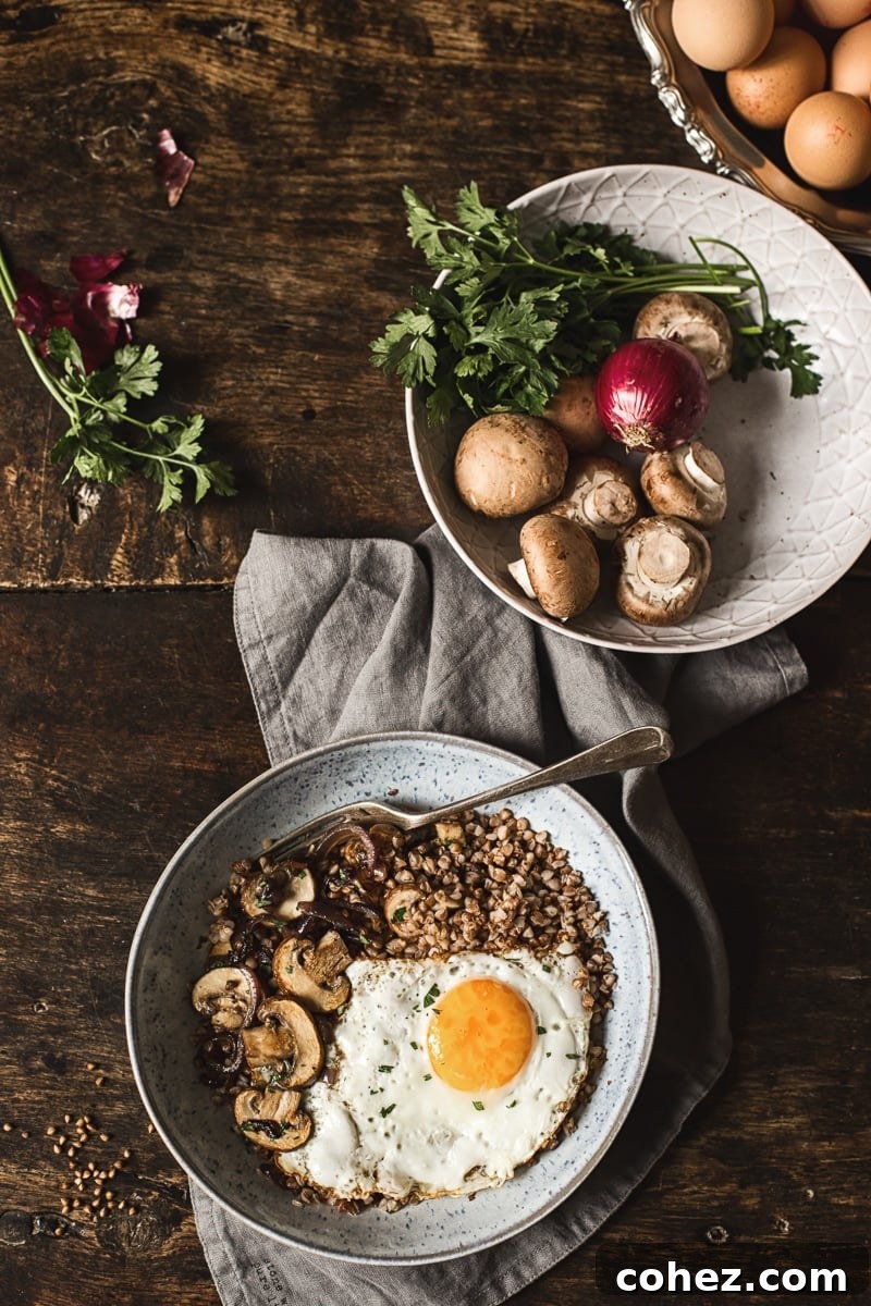 Overhead view of a prepared savoury buckwheat breakfast bowl, highlighting the perfectly cooked egg and vibrant ingredients.
