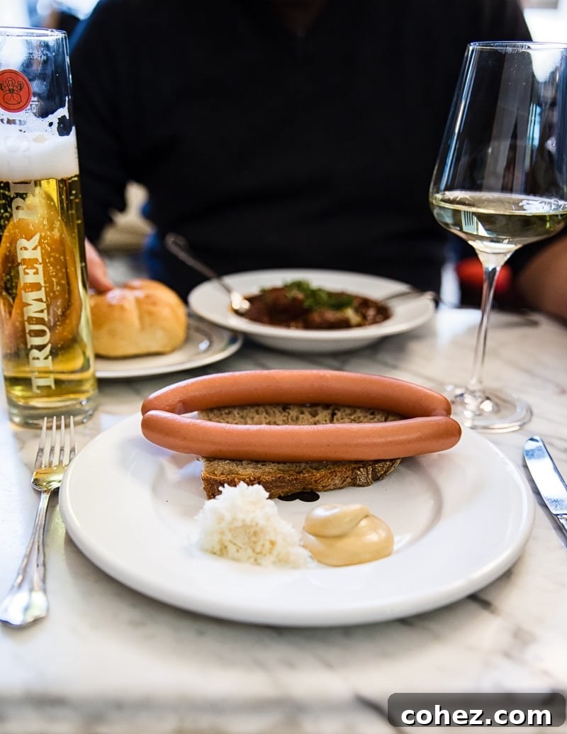 A delightful cafe lunch featuring sausage, local wine, and refreshing beer in Vienna