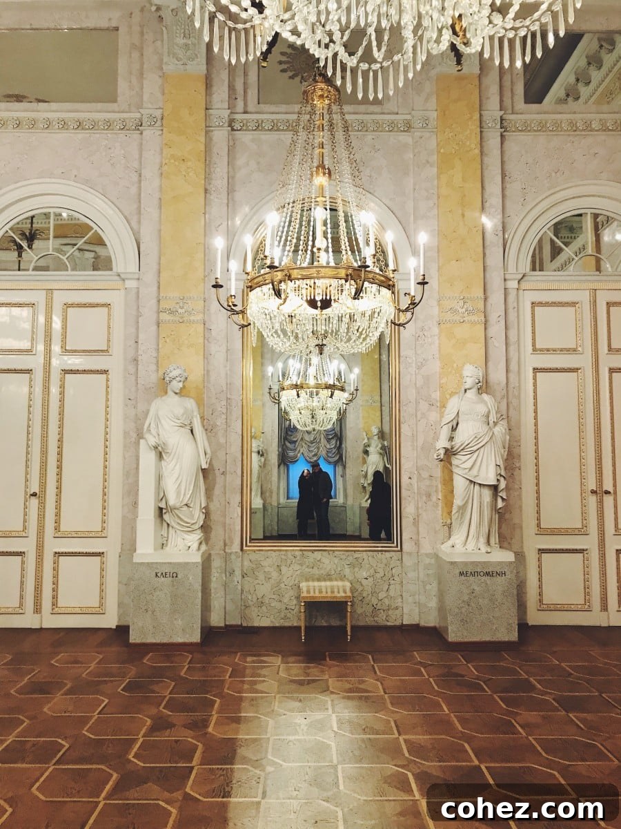 Elaborate chandeliers and statues adorning a palace hall within Schonbrunn