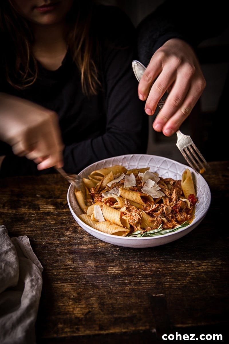 Hands reaching for portions of the dish with forks