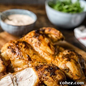 Oven-roasted spatchcock chicken with crispy skin and juicy meat, served with spicy yogurt sauce.