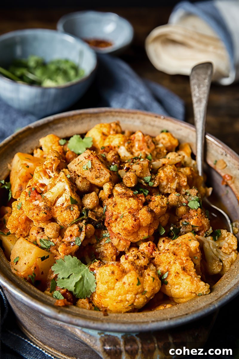 Simple Aloo Gobi Cauliflower Potato Curry 2 close up of cauliflower and potato curry in a clay pot