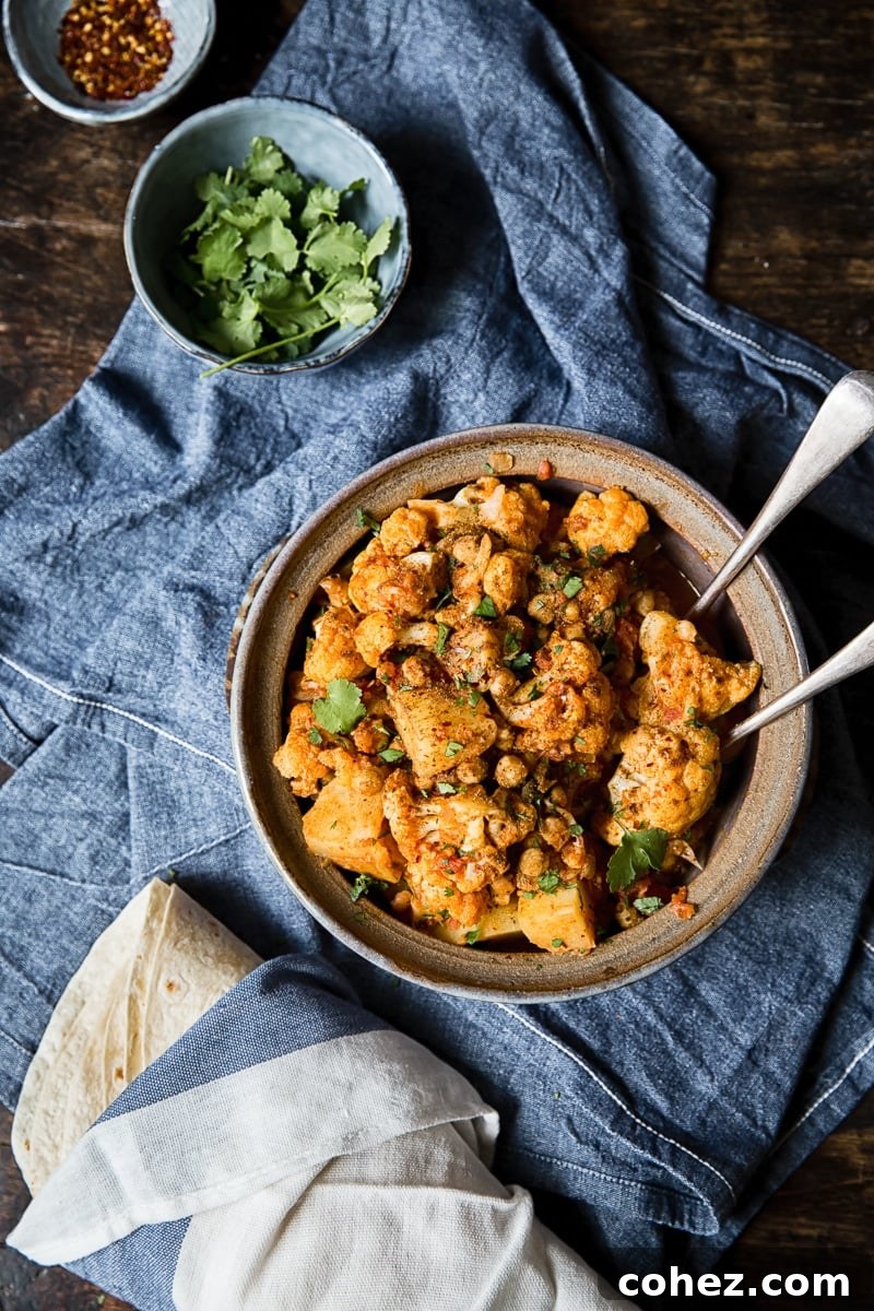 Simple Aloo Gobi Cauliflower Potato Curry 3 overhead shot of cauliflower and potato curry in a clay pot