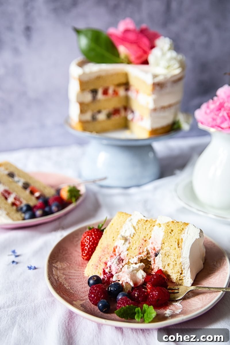 The Royal Bloom Elderflower and Lemon Cake 5 A beautiful side profile of the Elderflower, Lemon and Summer Berry Cake, showcasing its meticulously crafted layers and fresh fruit.
