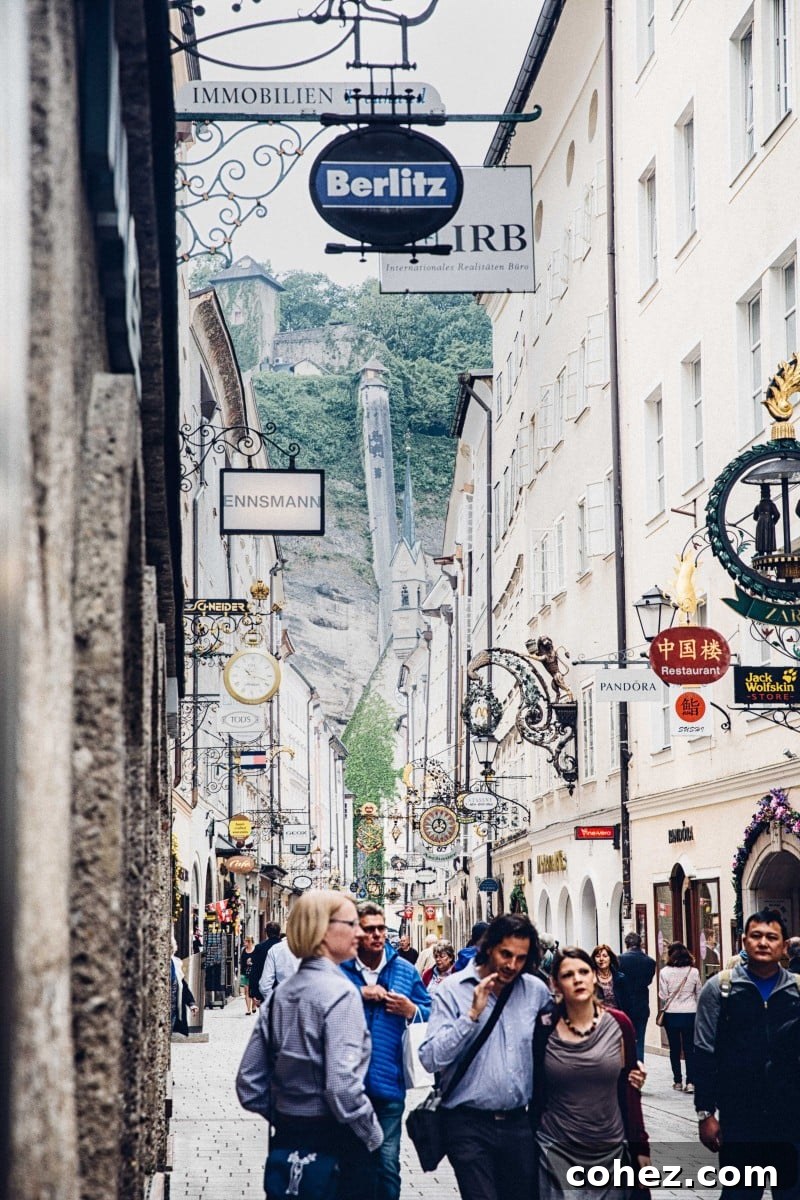 Salzburg's Brews and Baroque Wonders 3 The historic Getreidegasse, Salzburg's bustling main shopping street, adorned with unique wrought-iron guild signs and charming architecture.