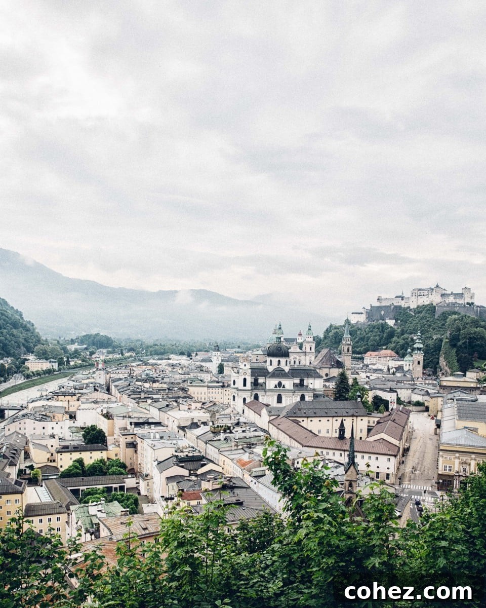 Salzburg's Brews and Baroque Wonders 4 A stunning cityscape of Salzburg, showcasing its historic buildings, the Salzach River, and the imposing Hohensalzburg Fortress perched above.