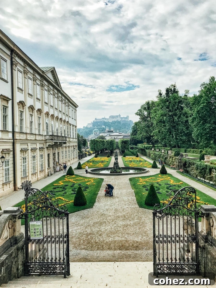 Salzburg's Brews and Baroque Wonders 5 A picturesque view of the meticulously manicured Mirabell Gardens in Salzburg, with the majestic Hohensalzburg Fortress visible in the background.