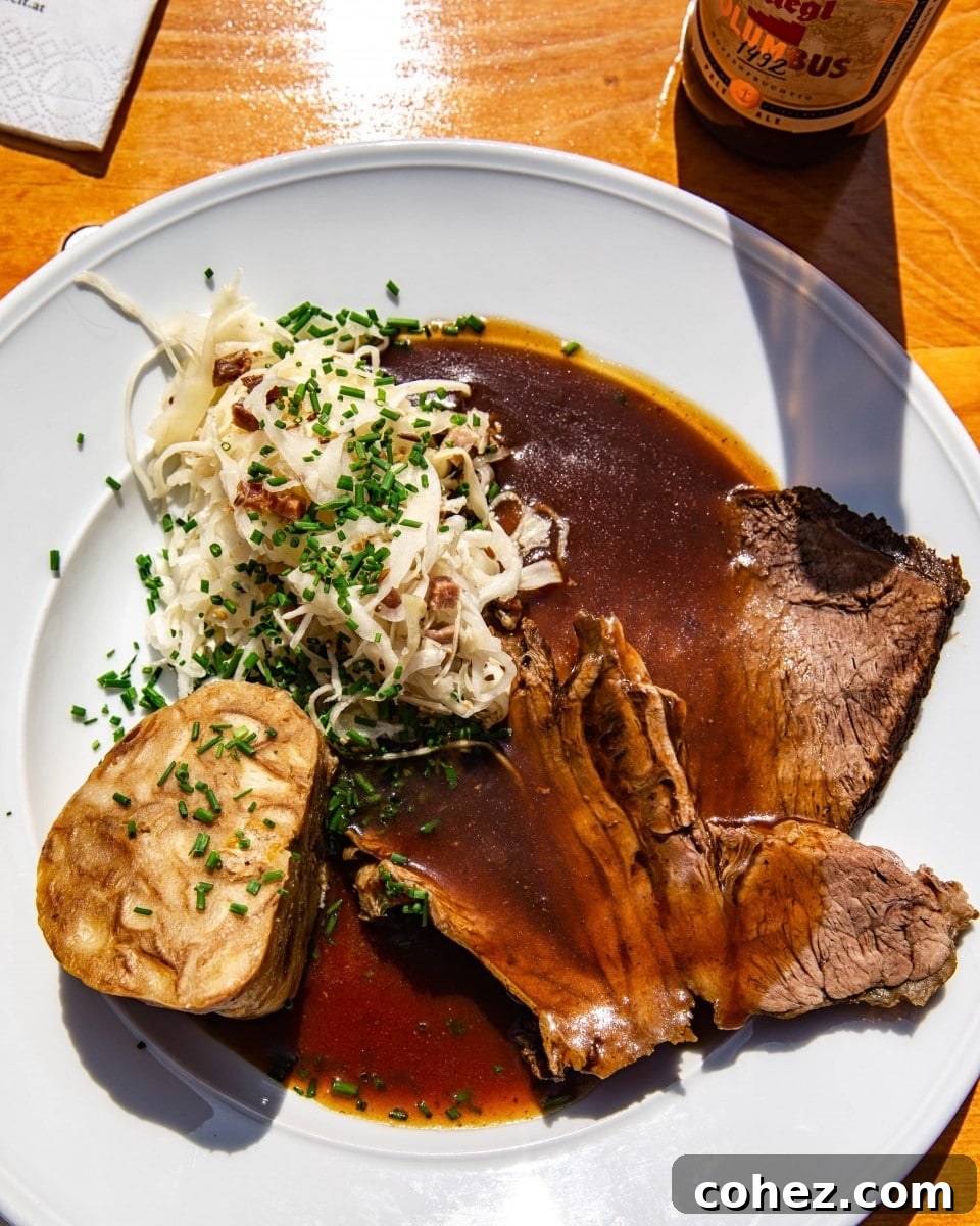 Salzburg's Brews and Baroque Wonders 10 A plate featuring a delicious traditional Austrian meal with tender meat, a fluffy dumpling, and flavorful sauerkraut, ready to be enjoyed.