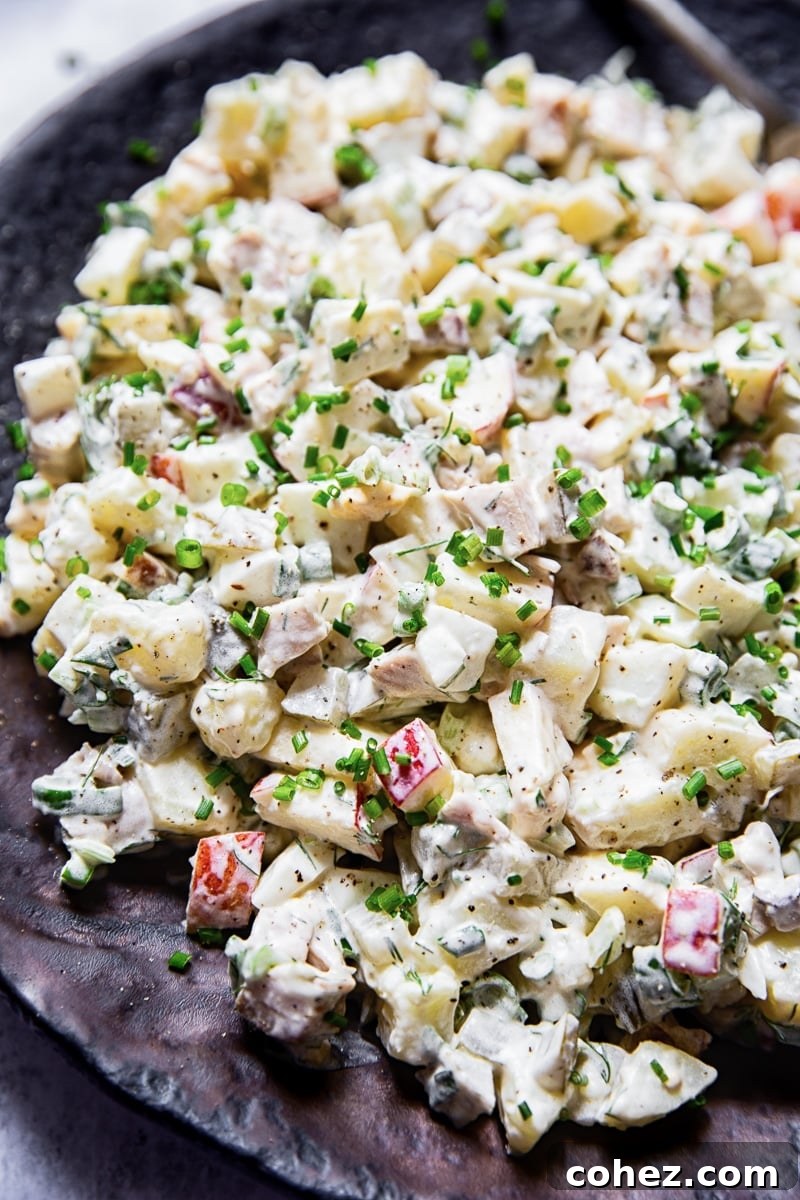 A close-up shot of the creamy and inviting Russian salad Olivier, showcasing its texture and rich blend of ingredients.