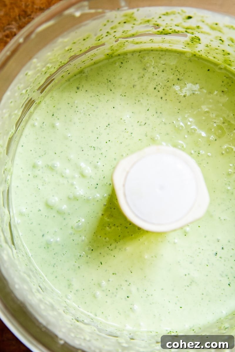 Close-up of freshly blended Green Goddess dressing in a food processor