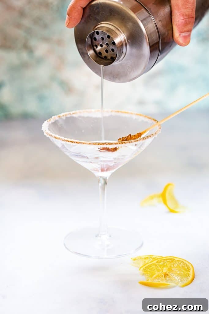 Close up of lemon drop martini pouring into martini glass