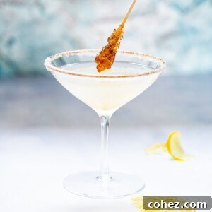 Side shot of sugar coated stir stick dipping into Lemon Drop Martini