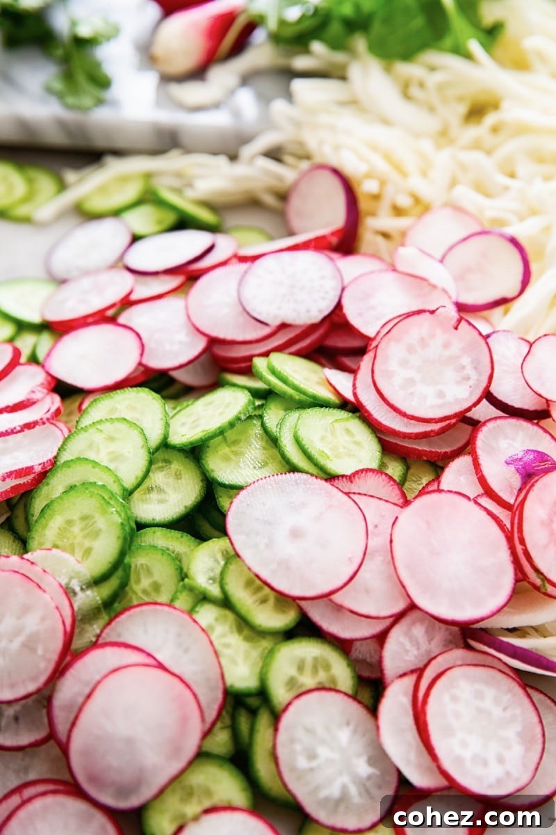 Close up of sliced cucumbers and radishes