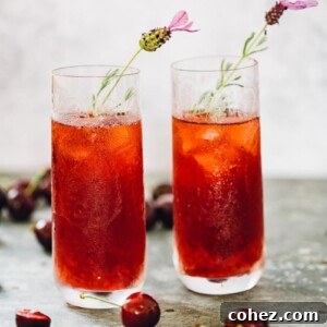 cherry long island iced tea in glasses with flower garnish