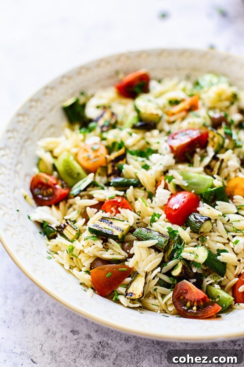 Ingredients for Greek Orzo Salad, including orzo, zucchini, and feta