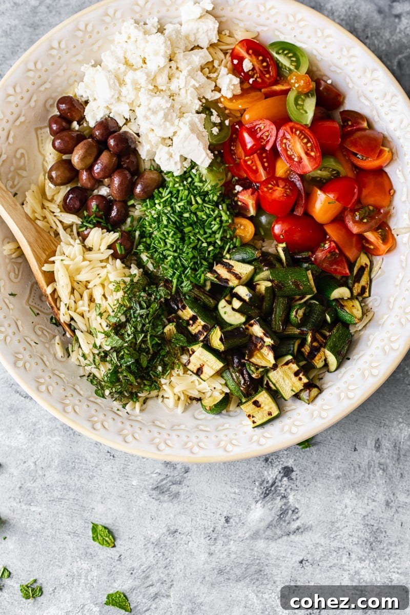 Close-up of Greek Orzo Salad featuring feta and olives