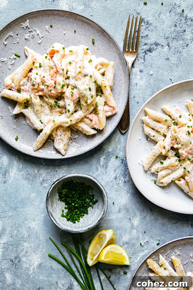 Decadent Smoked Salmon Pasta 3 Top down view of a bowl of creamy smoked salmon pasta garnished with fresh chives.