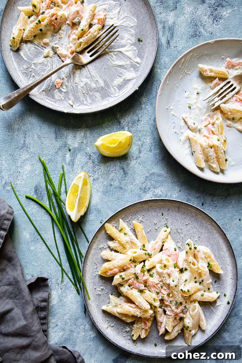 Decadent Smoked Salmon Pasta 6 Top down view of two plates of creamy smoked salmon pasta ready to be served.