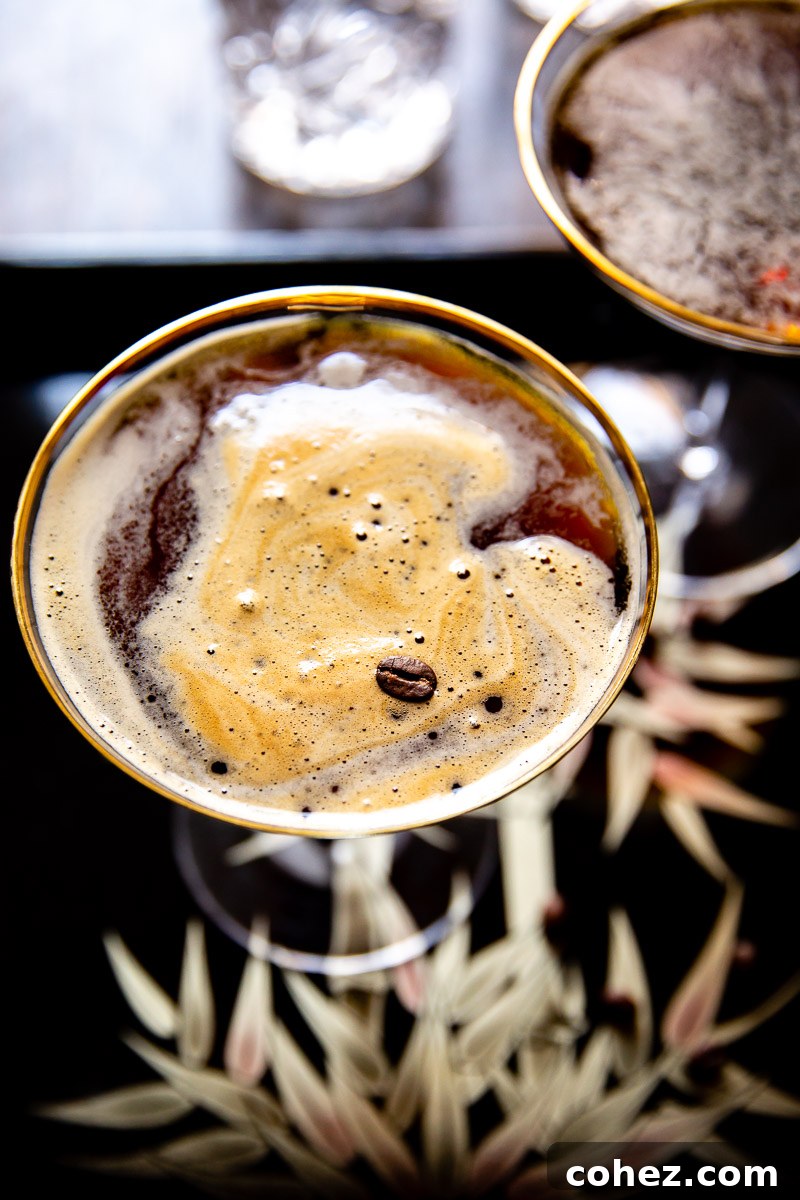 Close-up, top-down view of an Espresso Martini garnished with three coffee beans