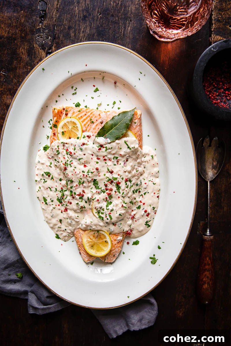 A top-down view of the beautifully baked salmon, generously coated in the luscious rosé cream sauce, ready to be served.