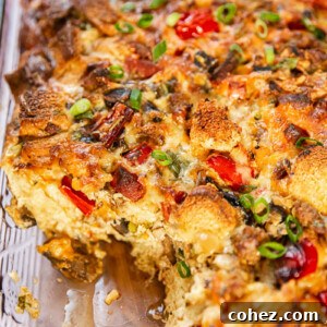Morning-Ready Sausage and Chorizo Egg Bake 6 Freshly baked overnight breakfast casserole, golden-brown and steaming in a rectangular baking dish, perfectly cooked and ready to be served.