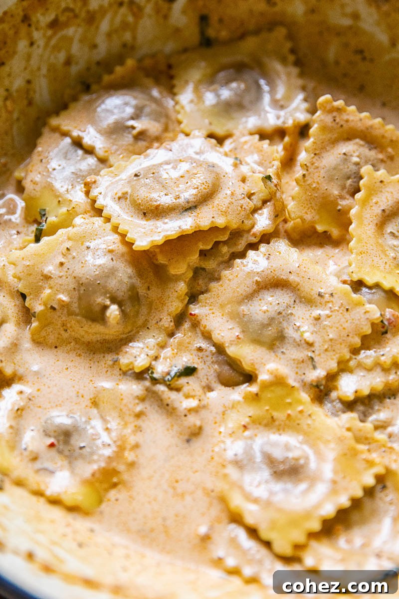 Perfectly coated ravioli in a creamy sun-dried tomato pesto sauce