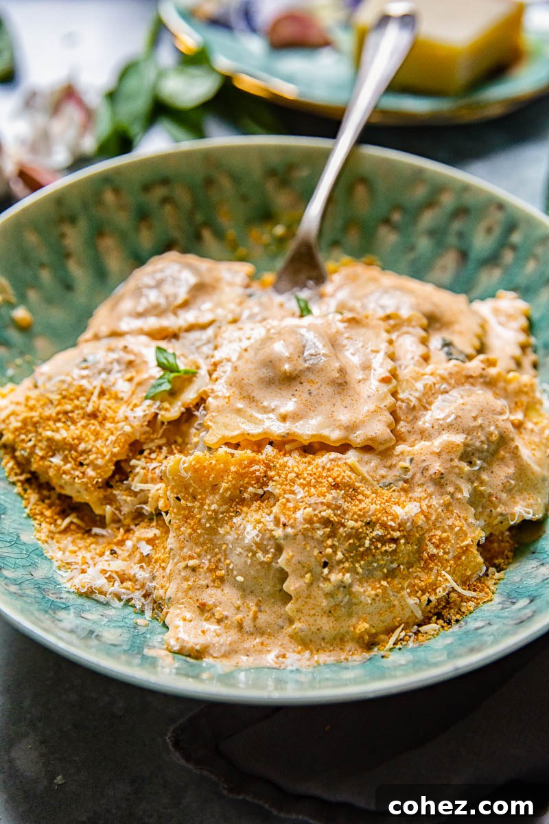 Garnished plate of ravioli with creamy sauce, basil, and Parmesan