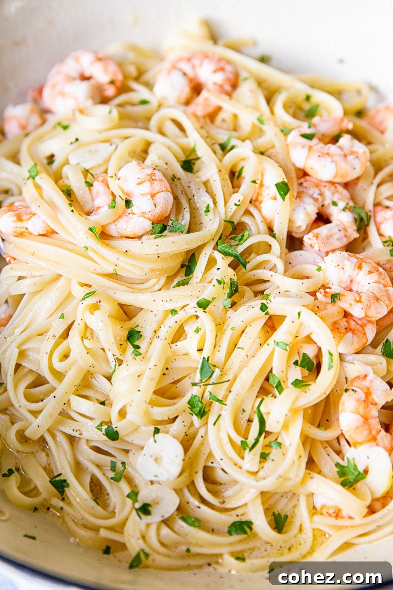 Lemon Garlic Shrimp Linguine 5 Close up view of Shrimp Scampi Linguine showing the glistening sauce and plump shrimp