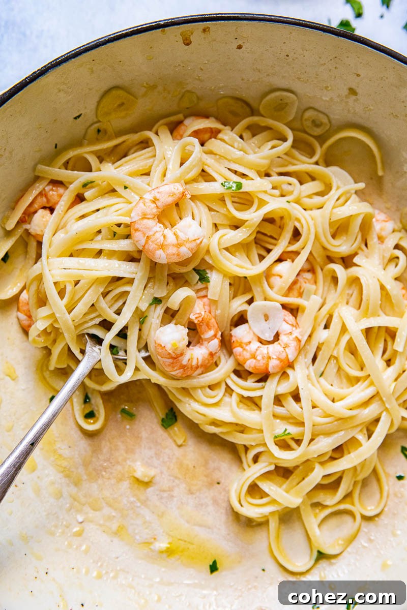 Lemon Garlic Shrimp Linguine 6 Close up view of Shrimp Scampi Linguine nestled in a pan, ready for serving