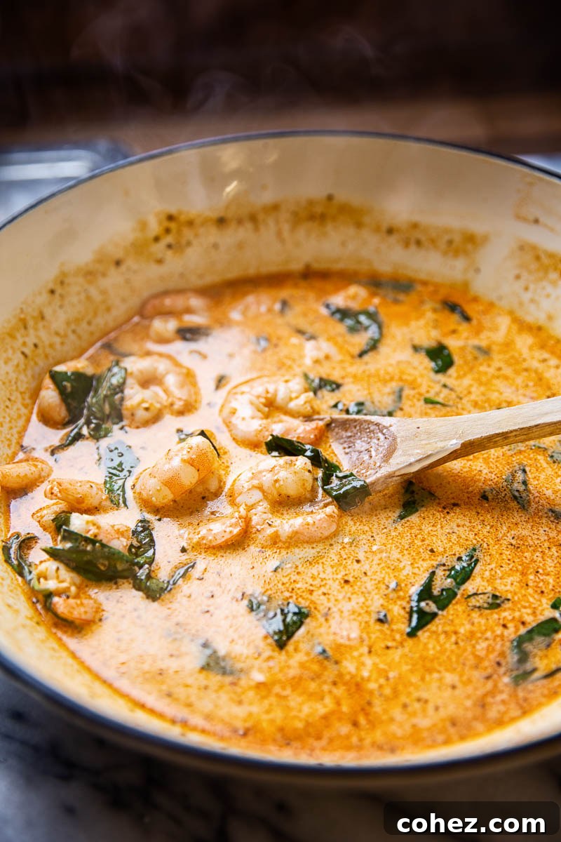 Close-up of creamy sun-dried tomato sauce with shrimp, ready to be tossed with pasta.