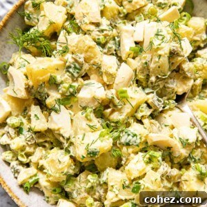 top down view of potato salad with dill and green onions