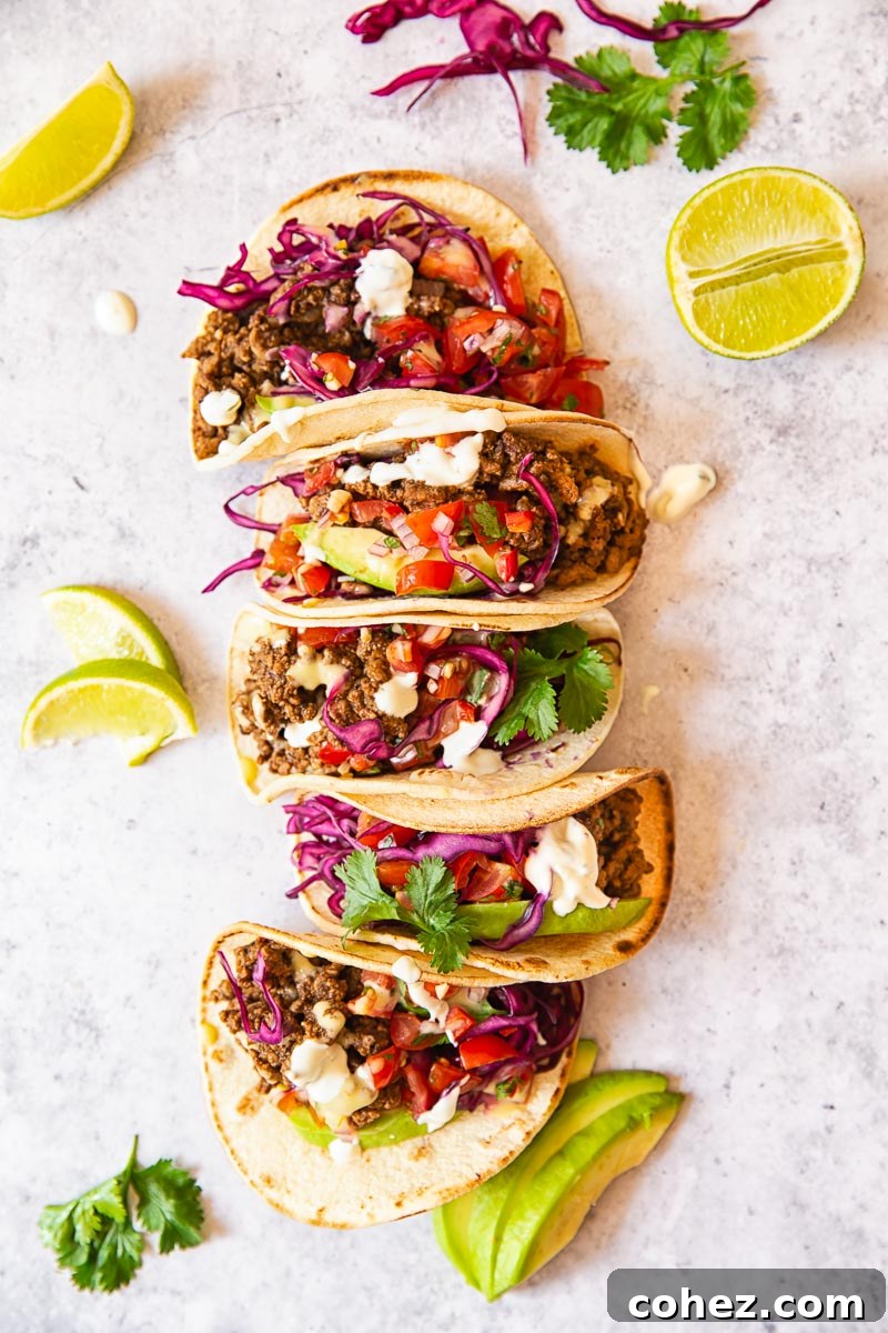 Ultimate Ground Beef Tacos with a Custom Spice Blend 5 Ground Beef Tacos topped with salsa, avocado slices and red cabbage slaw.