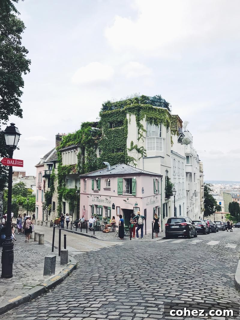 Building in Montmartre covered in ivy, and a cafe