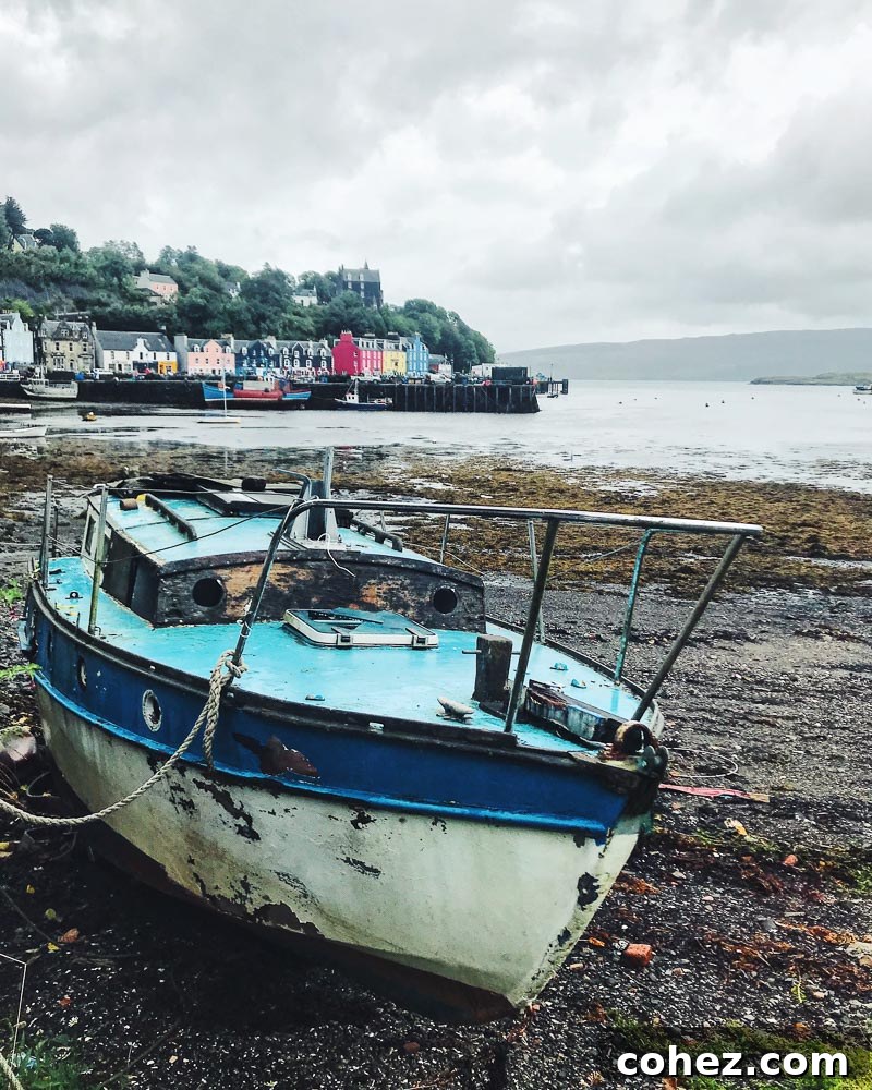 Mull: Where Scotland's Beauty Unfolds 10 Abandoned boat on the shore with Tobermory town in the background, Isle of Mull