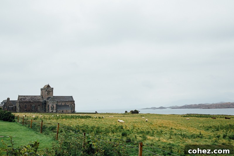 Isle of Mull Scotland's Untamed Beauty 9 The stunningly serene coastline of Iona, featuring a white sand beach, clear turquoise waters, and distant green hills under a bright, sunny sky.