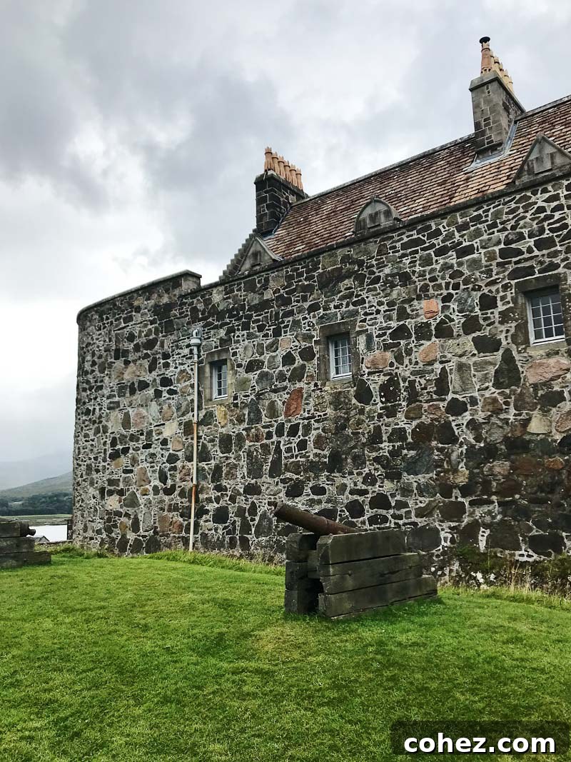 Isle of Mull Scotland's Untamed Beauty 10 The impressive Duart Castle on the Isle of Mull, Scotland, stands majestically on a rocky headland overlooking the sea, with lush green surroundings.