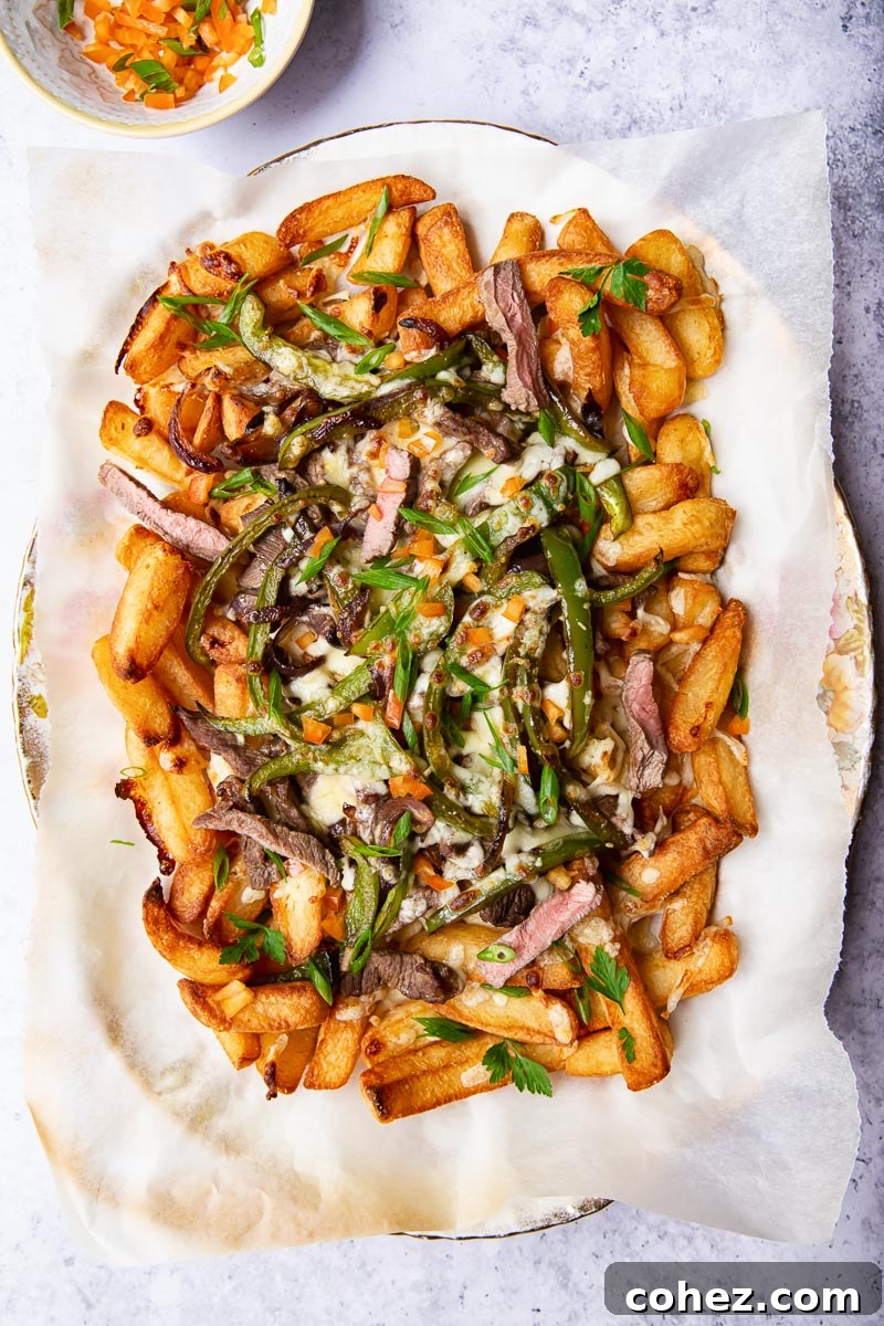 Smothered Philly Cheesesteak Fries 2 Fries loaded with steak, green peppers and melted cheese.