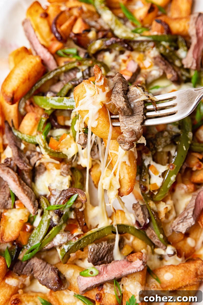 Smothered Philly Cheesesteak Fries 3 French Fries topped with steak strips, green peppers, onions and melted cheese.