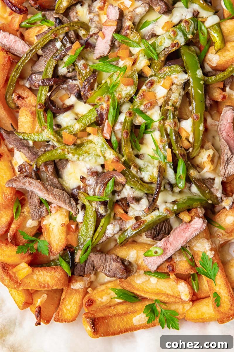 Smothered Philly Cheesesteak Fries 5 Chunky chips topped with strips of steak, green peppers, onions and melted cheese.