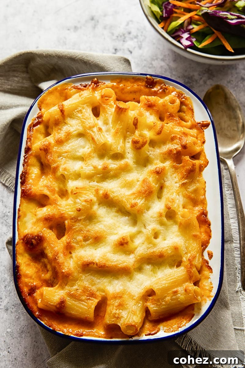 Nonna's Layered Macaroni Bake 3 Close-up of baked macaroni and cheese, showing golden-brown crust and creamy texture.