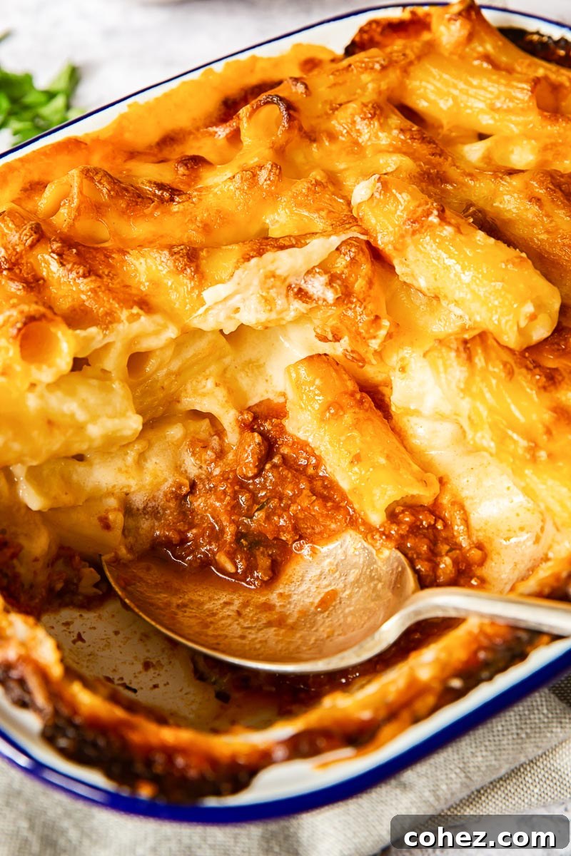 Nonna's Layered Macaroni Bake 4 Layered baked mac and cheese with a visible bottom layer of rich Bolognese sauce.
