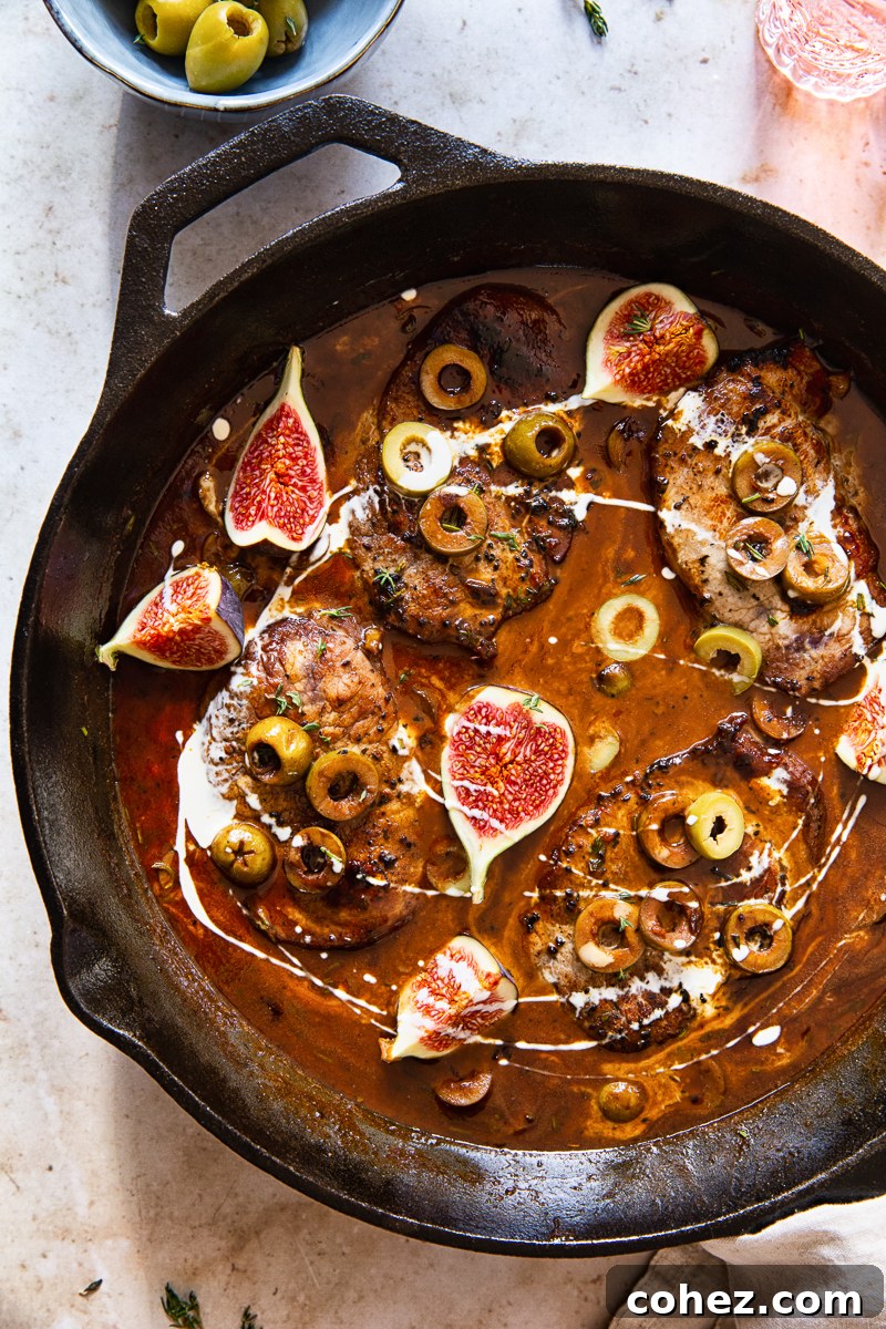 Perfectly cooked sweet and sour pork loin steaks, generously coated in sauce, and adorned with beautifully quartered fresh figs.