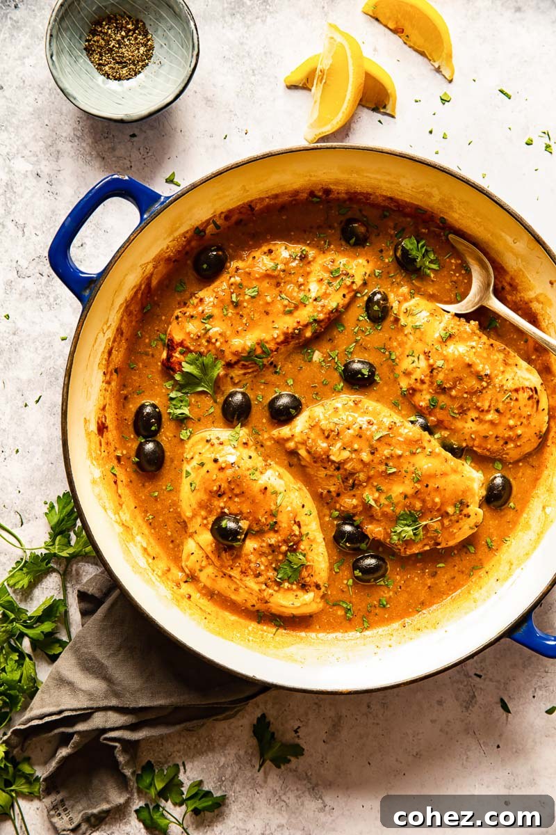 Lemon pepper chicken breasts generously coated in a rich, golden sauce with black olives.