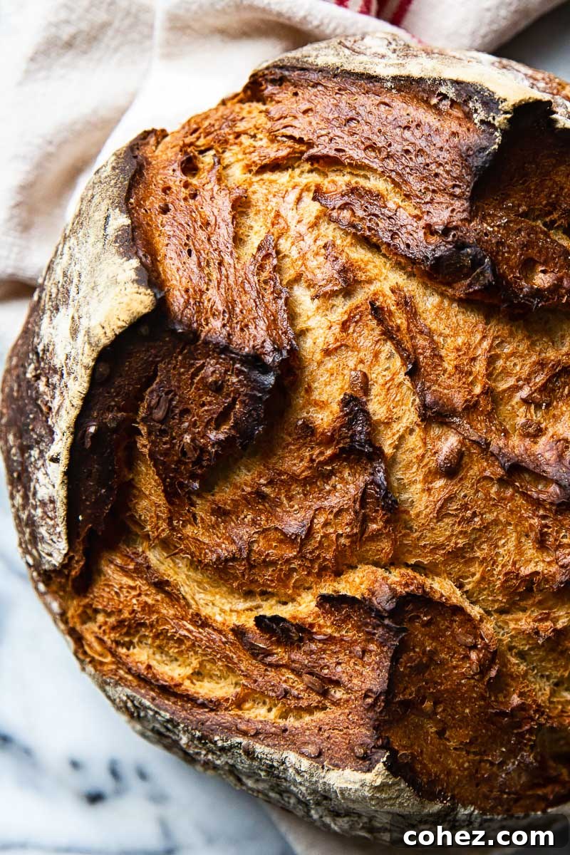 Rye Bread Mastery Baking with Rye Flour Unveiled 3 A perfectly baked, rustic dark rye bread loaf resting on a cutting board