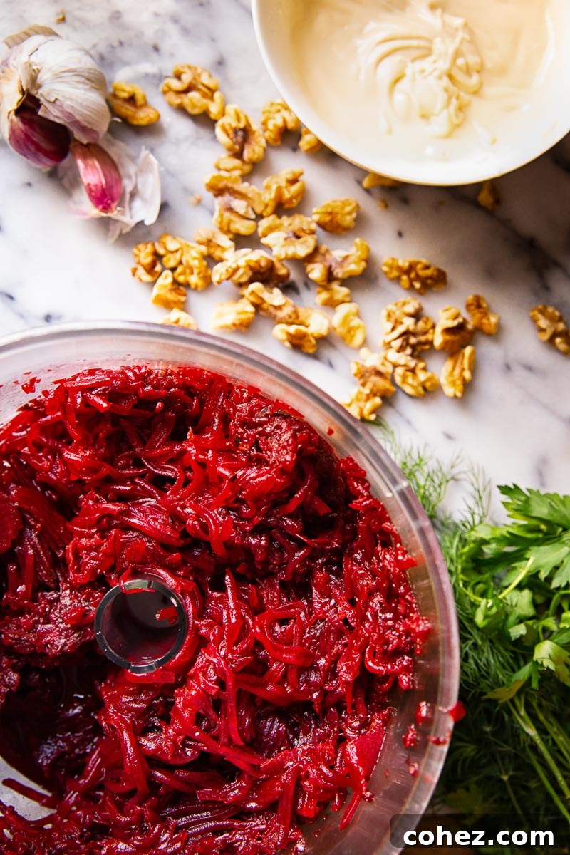 Vibrant Beet and Walnut Salad with Garlic Mayo 4 Various fresh ingredients for beetroot salad arranged on a marble surface