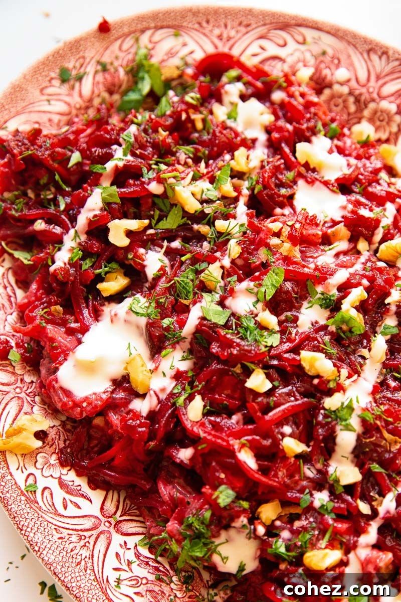 Vibrant Beet and Walnut Salad with Garlic Mayo 5 Close-up of beetroot salad with fresh herbs and walnuts, ready to serve