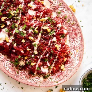 Grated beet salad sprinkled with herbs and walnuts