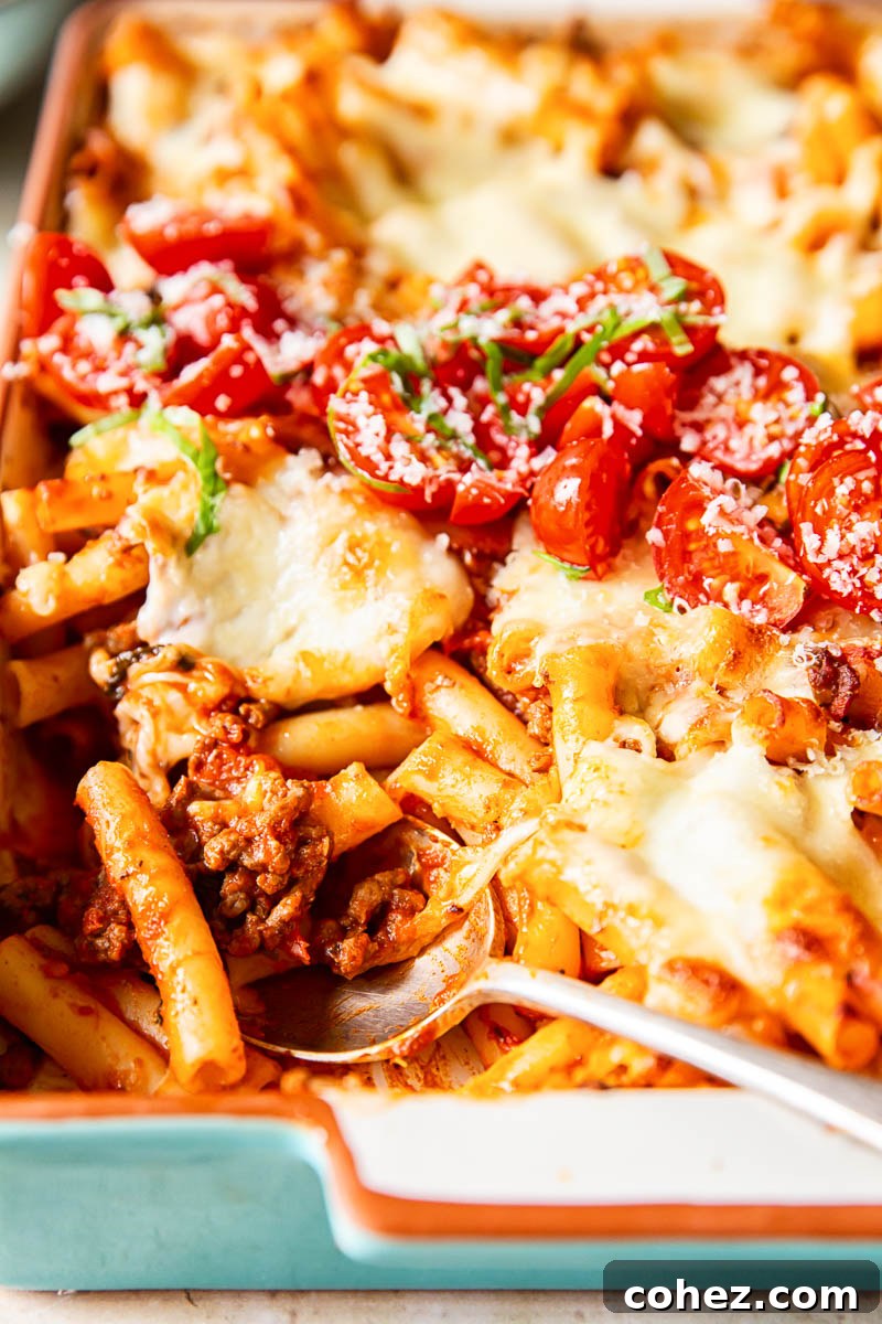 Quick Classic Baked Ziti 5 cheesy pasta bake with a spoon in the dish