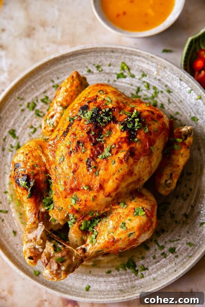 Instant Pot Whole Chicken Recipe with a generous drizzle of Thai Curry Sauce, served beautifully on a plate.